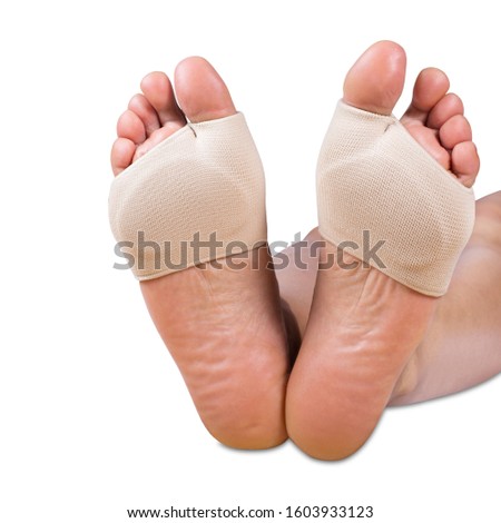 Metatarsal Sleeve Gel Pads on a white background. Woman feet with orthopedic pads isolated on white