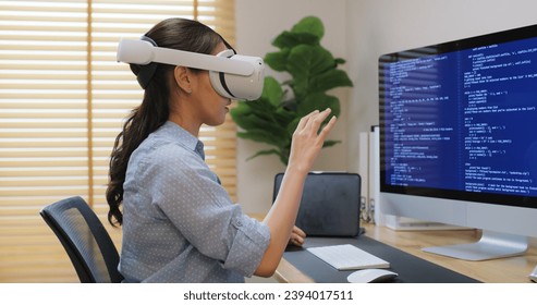 Metaverse app STEM platform developer future skill job workforce for asia people young woman work at home office wear VR headset typing test game on AI IT cyber security cloud computing web solution. - Powered by Shutterstock