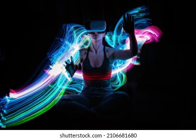 Metaverse digital Avatar, Metaverse Presence, digital technology, cyber world, virtual reality, futuristic lifestyle. Woman in VR glasses playing AR augmented reality NFT game with neon blur lines - Shutterstock ID 2106681680