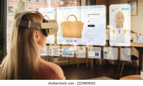 Metaverse Futuristic Concept: Woman Using Virtual Reality Headset to Shop Online from Home while Sitting in Stylish Cozy Living Room. Over the Shoulder Footage of a Female Shopper Choosing a Bag - Shutterstock ID 2229809055