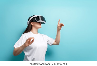 Metaverse technology concept. Woman with VR virtual reality goggles on light blue wall background. Futuristic lifestyle. - Powered by Shutterstock