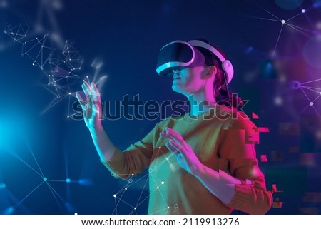 Metaverse technology concept. Woman with VR virtual reality goggles. Futuristic lifestyle.