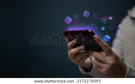 Metaverse, Web3 and Blockchain Technology Concepts. Closeup of Hand Using Smartphone for Connect a Community or Playing NFT Virtual Game