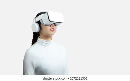 Metaverse, Woman In White Shirt Wearing Vr Glassess VR Set Equipment For Virtual Reality AI Concept On The White Background.