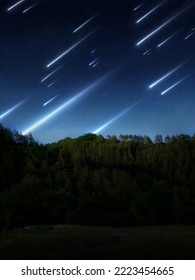Meteor shower over the hills. Bright stream of meteors in the night sky. Landscape with falling stars.