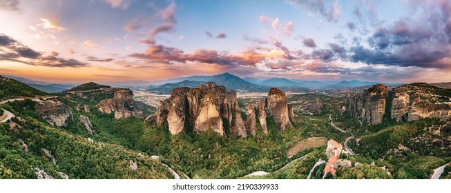 Meteora, Greece. Sandstone rock formations, the Rousanou and Nikolaos monasteries at sunset. Travel destination background. Panoramic view. - Shutterstock ID 2190339933