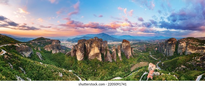 Meteora, Greece. Sandstone rock formations, the Rousanou and Nikolaos monasteries at sunset. Travel destination background. Panoramic view. - Shutterstock ID 2205091741