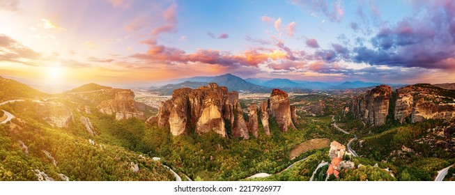 Meteora, Greece. Sandstone rock formations, the Rousanou and Nikolaos monasteries at sunset. Travel destination background. Panoramic view. - Shutterstock ID 2217926977