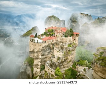 Meteora Varlaam Monastery rising out of the mist. Amazing mystical landscape.  A UNESCO heritage site. Meteora mountains, Thessaly, Greece. - Powered by Shutterstock