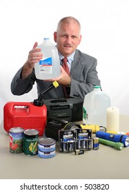 A Meteorologist With Hurricane Supplies, Holding Up A Jug Of Water