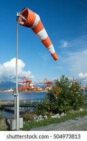 Meteorology Windsock With Port Metro Vancouver On The Background. Symbolizing Wind Of Change.