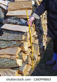 Metering splitted firewood log stack with folding meter close up