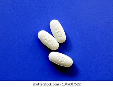 Metformine Prescription Pills With Identification Numbers On Blue Background 