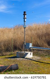 Methane Gas Flare With Fence And Dry Grass In Background.