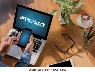 METHODOLOGY Freelance desktop with accessories and distance work tools, blank screen laptop computer and phone, sunglasses, coffee - Shutterstock ID 500645662