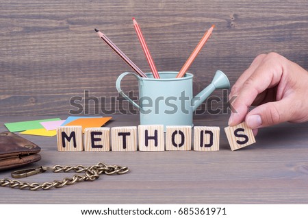  Methods. Wooden letters on dark background