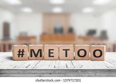 Metoo Hashtag Sign Made Of Cubes On A Wooden Table In A Courtroom