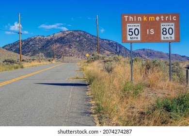 Metric To Imperial Measurement Speed Limit Sign From Miles Per Hour To Kilometers Per Hour At The Nighthawk Border Crossing In British Columbia, Canada.