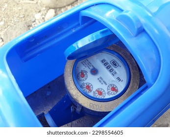 Metric water meter for household. Gauge, Open the water meter cover to check the water consumption counter number, water pipe and meter with home waterspout