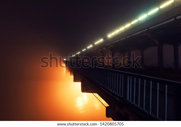 Metro bridge in Kiev\
in the fog at night 