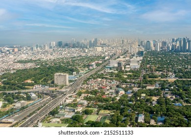 Metro Manila, Philippines - April 2022: The SLEX Skyway going towards the vast Metro Manila cityscape and skyline.