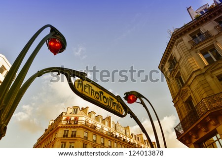 Metro station sign in Paris with beautiful background sky.