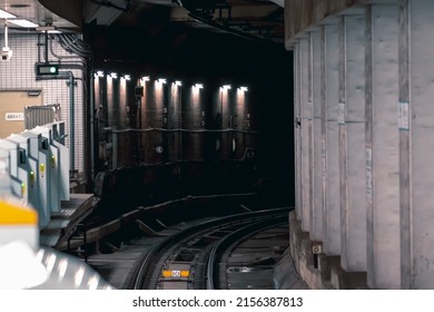 Metro Tunnel With Rail Track Running Along The Platform With Platform Screen Door Installed. TRANSLATION, Sign On Door Says 