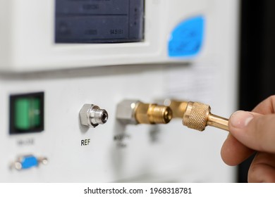 The Metrology And Standardization Laboratory Specialist Connects The Device Under Test Pressure Gauge To The Pressure Calibration And Verification Instrument.