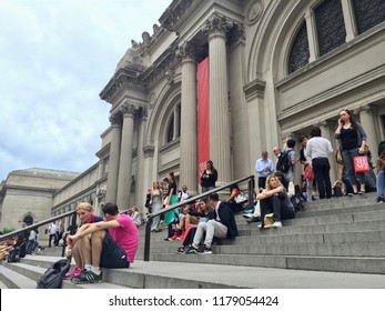 The Metropolitan Museum Of Art, Central Park, New York, United States - 28 June 2016: People Sitting At The Stairs In Front Of The Entrance.