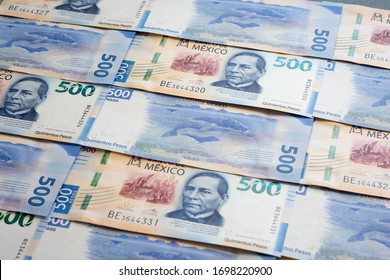 Mexican 500 pesos pile of blue bucks stack on top left close up