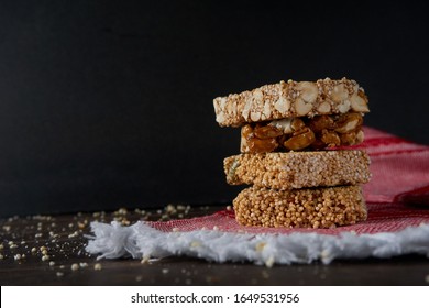 Mexican Amaranth Candy And Peanut Bar With Kitchen Cloth On A Wooden Table.                          