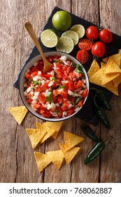 Mexican Appetizer Pico De Gallo Close-up In A Bowl On The Table. Vertical Top View From Above
