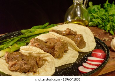 Mexican arrachera tacos with sides and herbs, low key with copy space
