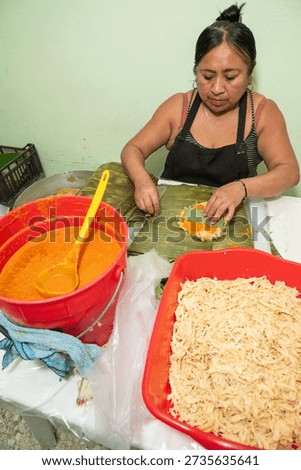 Mexican artisan adding aromatic hoja santa to Veracruz style tam
