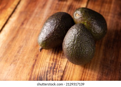 Mexican Avocado (persea Americana) On Rustic Wooden Table. Main Ingredient To Prepare Guacamole. Close Up Image With Copy Space.