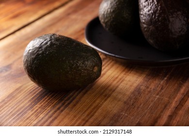 Mexican Avocado (persea Americana) On Rustic Wooden Table. Main Ingredient To Prepare Guacamole. Close Up Image With Copy Space.