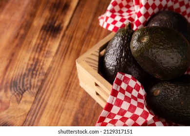 Mexican Avocado (persea Americana) On Rustic Wooden Table. Main Ingredient To Prepare Guacamole. Close Up Image With Copy Space.