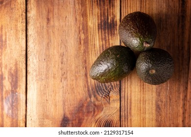 Mexican Avocado (persea Americana) On Rustic Wooden Table. Main Ingredient To Prepare Guacamole. Top Viewimage With Copy Space.