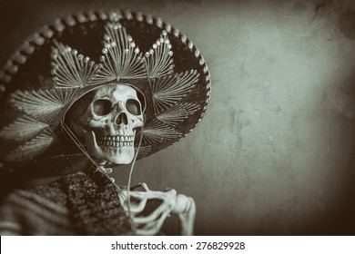 Mexican Bandit Skeleton 7. A skeleton wearing a Mexican sombrero and a poncho. Edited in a vintage film style. - Shutterstock ID 276829928