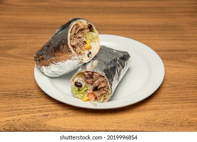 Mexican Beef Burrito With Rice, Black Beans, Sweet Corn, And Foil Wrapped Lettuce