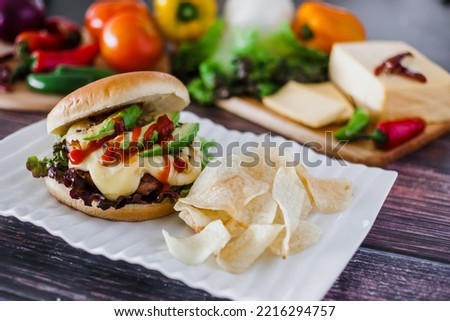 mexican burger with chips and avocado on table food with ingredients in Mexico
