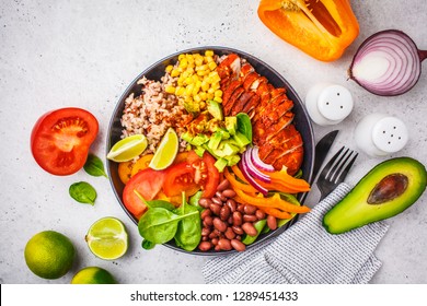 Mexican Chicken Burrito Bowl With Rice, Beans, Tomato, Avocado,corn And Spinach, White Background. Mexican Cuisine Food Concept.