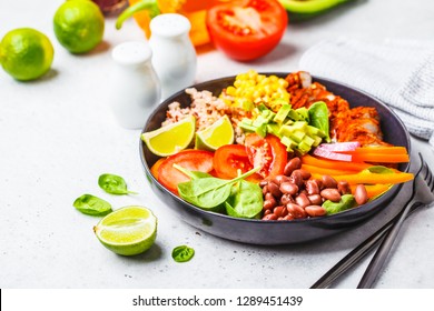 Mexican Chicken Burrito Bowl With Rice, Beans, Tomato, Avocado,corn And Spinach, White Background. Mexican Cuisine Food Concept.