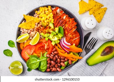 Mexican Chicken Burrito Bowl With Rice, Beans, Tomato, Avocado,corn And Spinach, White Background. Mexican Cuisine Food Concept.