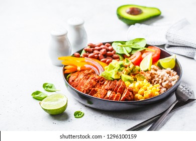 Mexican Chicken Burrito Bowl With Rice, Beans, Tomato, Avocado,corn And Spinach, White Background. Mexican Cuisine Food Concept.