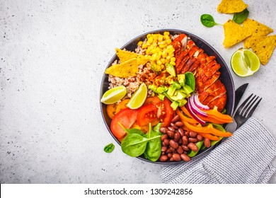Mexican Chicken Burrito Bowl With Rice, Beans, Tomato, Avocado,corn And Spinach, White Background. Mexican Cuisine Food Concept.