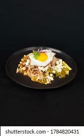 Mexican chilaquiles in a black background