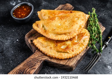 Mexican chilean food fried empanadas pie with beef meat. Black background. Top view.