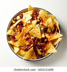 Mexican Chili Con Carne With Nachos Topped With Cheese And Baked In An Oven Viewed From Overhead In A Dish Over White