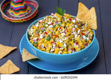 Mexican Corn Appetizer Elote.  Roasted Street Corn Salad Or Dip With сilantro, Lime, Cheese, Mayonnaise And Chili Served With Chips.




